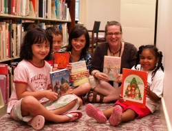 Young readers with books from the Library's curriculum collection