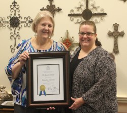 Library Dean Sara Baron (right) presents the certificate of Librarian Emeritus to Leanne.