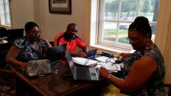 Ed.D. student Sharon Gardner (right) and guest scholars make full use of the new electrical and USB ports.