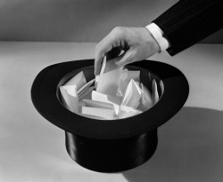 1930s man's hand in top hat full of paper pulling name out of hat